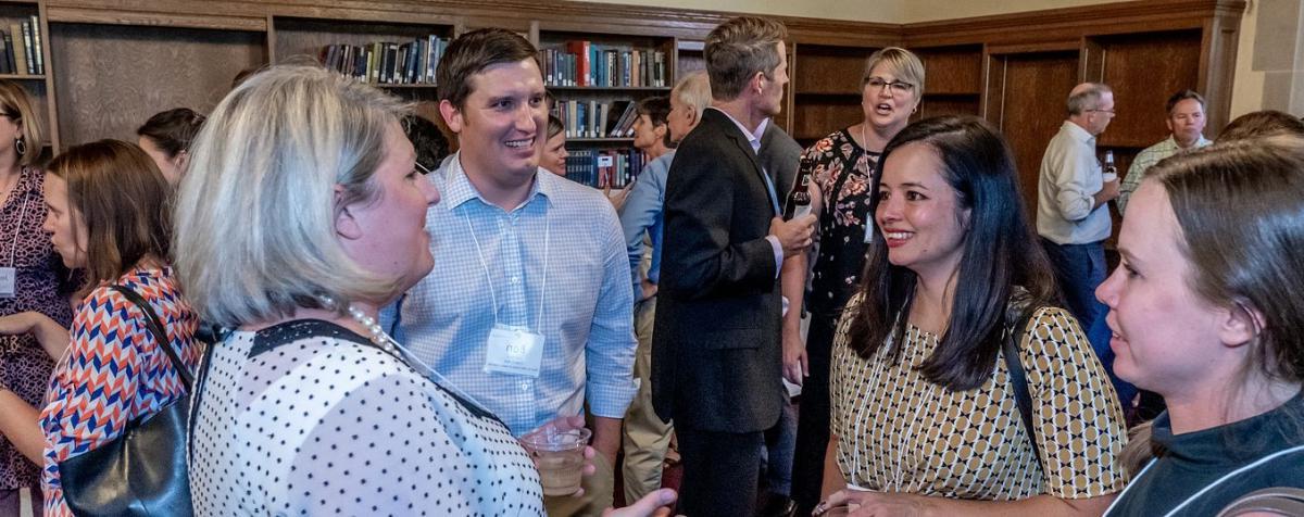 Graduate Students talking at an event